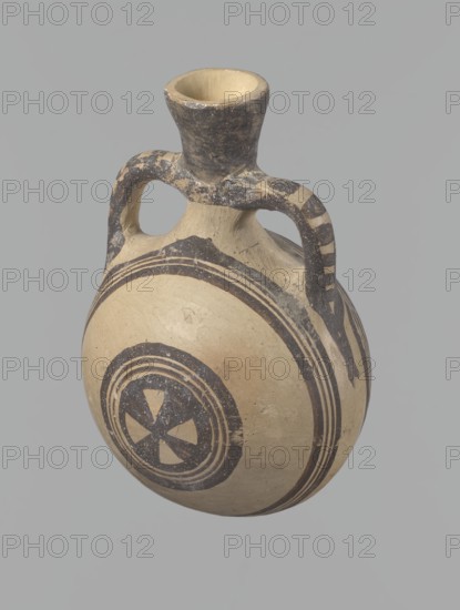 Canteen, Cyprus. Cypriot ceramics, White Painted I . Vessel decorated with concentric circles. Spherical, slightly flattened body width one side 8.5 cm, other 7.3 cm with two vertical cylindrical handles and a narrow neck; slightly flaring spout reconstructed. Pinkish clay with creamy engobe and black-brown decoration. On the handles: horizontal lines framed by thick lines connected at the neck at the attachment point, intersecting below the handles. Both flattened sides decorated identically with two sets of concentric circles four lines each: two narrow lines framed by wider lines. Outer line of outer band overlaps the neck and slightly extends over the handle mounts, widening there. Center of the inner band filled with a Maltese cross motif. Good condition: reconstructed spout and upper half of neck; limescale deposits removed. Numerous abrasions, especially on neck and handle mounts. Dated 1050–950 BC Cypriot Geometric Period I, Cyprus, vessel., A rounded ceramic vessel with a narr...