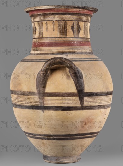 Amphora, Cyprus; large amphora with two horizontal handles, rounded shoulders, and a neck narrowing in the middle, ending with a profiled rim. Geometric motifs; decoration in red and black: on the neck—sets of lines, stripes, vertical lines, and triangles; on the belly—black lines and stripes. Cypriot pottery, 850–750 BC. Vessel; height 64.2 cm, width 42.4 cm., A large pottery jar with a rounded body and a flared neck is shown against a plain gray background. The jar's surface is mainly beige with areas of darker tan and small discolorations. Several horizontal bands in black encircle the body, including pairs of thin black lines forming striped bands and broader solid black bands. The neck features decorative patterns with thin black vertical lines and a band of reddish color near the rim. A curved, dark brown handle arcs from the shoulder toward the neck, appearing worn and textured. The rim and base show darker brown and gray tones.
