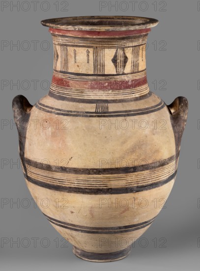 Amphora, Cyprus, geometric motifs, Cypriot pottery. Large amphora with two horizontal handles, rounded shoulders, and a neck narrowing in the middle, ending with a profiled rim. Decoration in red and black: on the neck formed by sets of lines, stripes, vertical lines, and triangles; on the belly formed by black lines and stripes. 850–750 BC. Vessel. Height 64.2 cm; width 42.4 cm., A large rounded ceramic vessel with a narrow base, bulbous body, and flaring neck, shown against a gray background; the vessel surface is primarily beige and cream with areas of darker patina and some reddish discoloration, and it features several horizontal bands and stripes in black and dark brown, plus a broad reddish band near the neck; there are geometric decorative motifs in dark paint around the upper neck and a few worn spots and surface blemishes; short rounded handles with darker coloring are attached near the shoulder on either side.