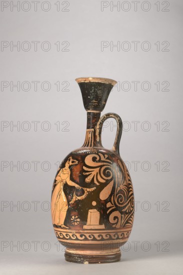 Red-figure aryballus lekythos with a depiction of Eros and a woman, Darius Painter 340–320 BC, Apulia; vessel lekythos, aryballus lekythos; height 23.3 cm, width 10.7 cm., An ancient-style ceramic vessel with a narrow flaring neck and single curved handle mounted on an oval body, displaying a black background with orange-painted figures and swirling floral motifs, showing a standing robed female figure rendered in orange against black, decorative scrollwork and palmette shapes, a patterned band near the base, and areas of wear revealing lighter clay; visible colors include black, orange, brown, and traces of beige.
