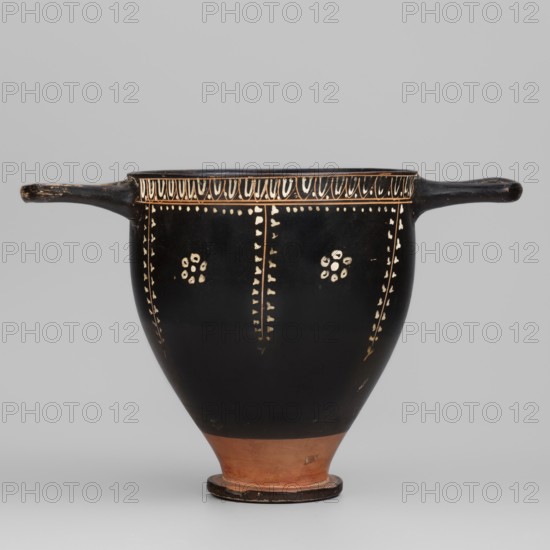 Gnathian skyphos with depiction of an altar, Gnathia style, Southern Italic pottery, ca. 340–ca. 320 BC, Southern Italy Italy, vessel, skyphos, weight 0.168 kg, altars iconography, A black ceramic vessel with a rounded body tapering to a terracotta-colored foot and a small circular base, featuring a pair of horizontal handles extending from opposite sides; the upper rim is decorated with a repeating light-colored pattern and a dotted band, and the body shows vertical dotted lines and small floral-like clusters in a light color against the black surface, with visible wear and small chips on the handles and foot; colors visible include black, terracotta, and a light cream.