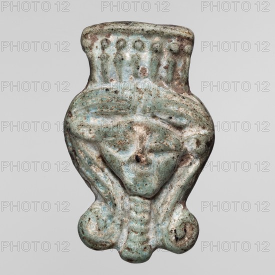 Amulet — head of the goddess Hathor;, Face of the goddess Hathor in a Hathor wig with a wreath of uraei. Materials/technique: amulet. Subject: Hathor Egyptian deity, uraeuses, wigs. Date: ca. 1069–ca. 656 BC, Third Intermediate Period, Egypt. Dimensions: height 2 cm, width 1.6 cm., An aged pendant-like object with a worn turquoise surface showing areas of light blue, greenish-blue, pale beige, and brown discoloration, shaped like a stylized face with a rounded top, a broad forehead decorated with a row of raised bumps, shallow indentations suggesting closed eyes, a subtle nose area, and a small central hole; the lower portion tapers into a curved, symmetrical base with scroll-like rounded ends and vertical grooves, and the surface displays pitting and uneven texture from wear.