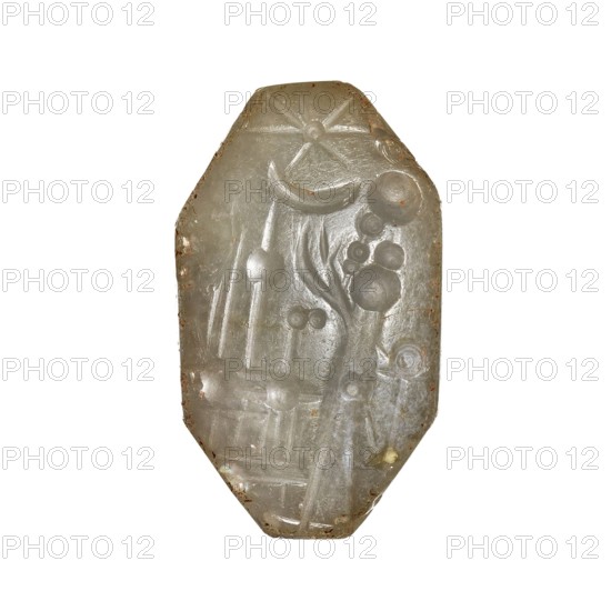 Stamp seal with a scene of adoration of divine symbols, unknown Neo-Babylonian workshop. On the octagonal, slightly convex base of the seal, there is a scene, schematically executed in concave relief, of a standing figure priest? adoring divine emblems placed on a two-story openwork platform altar?. The emblems on the platform are interpreted as a spade, an attribute of Marduk, the main god of Babylon, and a stylus, an attribute of Nabu, the god of scribes, wisdom and magic. At the top of the scene, two astral symbols are shown—a star and a crescent moon, identified with Shamash the sun god and Sin the moon god. 6th century BC; Neo-Babylonian period, Southern Mesopotamia, Babylonia, Iraq. Seal; height 3.2 cm, width 2.5 cm, depth 1.45 cm., A translucent, pale green-gray stone or carved object with an elongated octagonal shape showing carved raised patterns including curved lines, circular raised dots, and rounded forms; the surface has a smooth, slightly glossy texture with small browni...