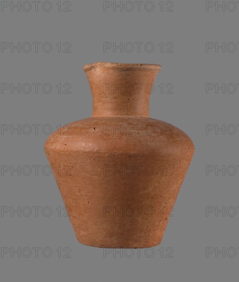 Jug, Egyptian pottery, clay vessel, cylindrical with flaring neck, c. 2686–c. 2181 BC Old Kingdom, from Edfu; height 18.6 cm, rim diameter 8.5 cm, body diameter 15.8 cm, bottom diameter 9.1 cm., A single terracotta vessel with a wide rounded shoulder narrowing to a slightly flared neck sits against a plain gray background; the pot shows an unglazed, matte surface in warm brown and reddish-brown tones with a few darker flecks and small surface irregularities, and the gray background appears uniform and neutral.
