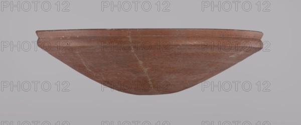 Medum-type bowl, Egyptian pottery, Medum-type bowl with characteristic carination under the rim. Rounded bottom. Straight, slightly flaring rim. Narrow, sloping shoulders. The diameter of the rim equals the diameter of the vessel's shoulders. Clay probably NB1. The surface was leveled and covered with a layer of engobe, then polished. Vessel color: red. Vessel glued together from original fragments. Minor losses on the rim. c. 2686–c. 2181 BC; Old Kingdom, Edfu. Vessel; height 6.9 cm, diameter 24.5 cm rim, diameter 24.9 cm shoulders., A large shallow bowl viewed from the side with a rounded underside and a slightly flared rim, showing a worn, coarse surface with visible repair lines and small chips; the bowl is primarily reddish-brown with lighter tan streaks and flecks, set against a pale gray background.