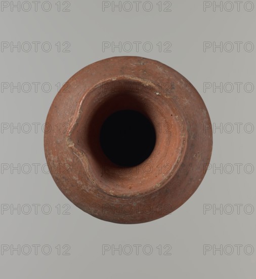 Vessel, Medium-sized jug with a biconical body, widest at about half its height; wide shoulders, not very sloping. Wide, almost cylindrical neck widening toward the spout, the neck about one-third of the vessel's height. Profiled, irregular spout, slightly raised and extended on one side forming a small spout; spout nearly triangular in cross-section with an approximately millimeter-sized cylindrical bulge on the outer profile. Bottom almost flat with a very slight rounding. Made of Nile clay NB1? according to the Vienna System. Neck made separately and attached to the shoulders. Outer surface smoothed, covered with an engobe and polished; inner surface smoothed, except for the neck, which is also covered with engobe and polished. Reddish-brown color. Quite well preserved; rim slightly chipped in two places and outer engobe worn in places. Comparative parallels: Saqqara II cat. 210–211, form 35; similar vessel from the same excavations Louvre E 16586. Circa 2345–2181 BC; Old Kingdom, 6...