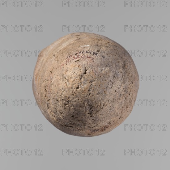 Vessel, Egyptian pottery, ceramics, clay, hand-made vessel; Old Kingdom, c. 2686–c. 2181 BC; provenance: Edfu; vessel; height 33.5 cm, rim diameter 10.4 cm, body diameter 15.1 cm., A roughly spherical, weathered object with a coarse, pitted surface floating against a uniform gray background, showing a textured mix of beige, tan, light brown, and hints of gray with small darker brown speckles and subtle areas of reddish-brown; the surface appears uneven with indentations and raised ridges, and a few faint darker marks are visible on one side.