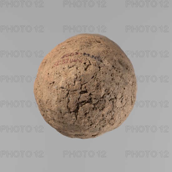 Vessel, Egyptian pottery, handmade clay vessel; almost cylindrical, widest just below a straight, tapering rim; rounded bottom; slightly marked, irregular, very narrow, sloping shoulders. Made of Nile clay with numerous organic inclusions and limestone particles; surface uneven, better worked in upper part, with many uneven depressions especially at the bottom. Color brown. Fairly well preserved; surface cracks attributed to careless craftsmanship in kneading and firing. Old Kingdom, ca. 2686–2181 BC; from Edfu. Height 36.5 cm; rim diameter 11.5 cm; body diameter 13.2 cm., A roughly spherical, textured object with a rough, cracked surface occupies the center against a plain gray background; the object shows a mix of brown and tan tones with small areas of darker brown and faint reddish patches, and its surface has irregular pits, crevices, and crumbly areas giving it an earthy, porous appearance.