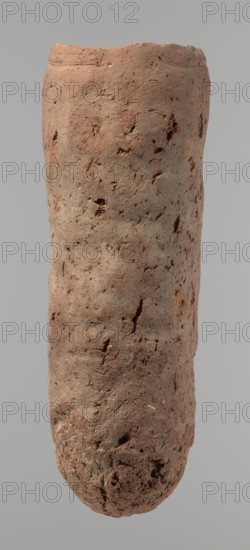Vessel, Egyptian pottery, hand-made clay vessel. An almost cylindrical vessel, widest in its upper part just below a straight, slightly tapering rim; rounded bottom; shoulders almost illegible. Handmade of Nile clay with numerous organic inclusions and limestone particles visible on the surface; carelessly made with uneven depressions, especially at the bottom; brown in color; cracks on the surface attributed to craftsmanship, kneading and firing. Old Kingdom, ca. 2686–2181 BC; Edfu. Vessel; height 37.9 cm; diameter 11.4 cm rim, 12.5 cm body., A tall cylindrical object with an uneven, rough surface showing a group of small pits and cracks, colored mostly reddish-brown with areas of grayish-brown and hints of darker brown; the top edge is slightly irregular and the bottom is rounded and more textured, with varying surface shadows against a pale gray background.