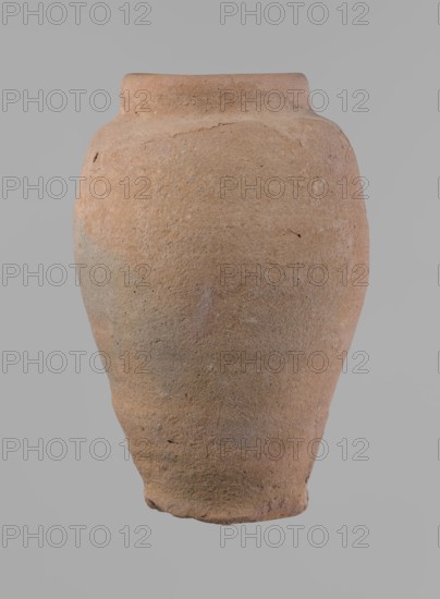 Vessel, Beer jug of a slightly irregular, conical shape with a wide, very short neck and a flat bottom. Flat, narrow shoulders and a gently rounded, straight rim. Wheel-made of Nile clay type NB2 Vienna System classification. Bottom is cut off with string and bears clear potter's fingerprints, flaring slightly in its lowest part. Surface even. Color: red. Complete and fairly well preserved, with minor damage to the bottom. New Kingdom, ca. 1550–1069 BC. Height 24 cm; diameters: rim 10 cm, body 16 cm, bottom 9.2 cm., A large rounded vessel with a narrow neck and flared rim, showing a coarse, uneven surface texture and small pits and imperfections; the vessel appears clay-made with colors of terracotta, muted brown, beige, and touches of gray, set against a plain light gray background.