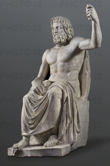 Statue of Jupiter of the Capitoline type, unknown Roman workshop. Jupiter Zeus seated on a throne set on a rectangular base. Zeus sits stiffly with torso slightly back; his raised left hand holds a scepter and his right hand rests on his right knee. Right foot slightly forward. Legs covered with a himation that also covers the back and left shoulder. Muscular torso, strongly developed shoulders, with naturalistic modeling. Head disproportionately large; face with slightly open mouth. Hair parted from the center anastole. Beard thick, arranged in strands on the sides and in curls on the chin. Roman sculpture, Roman copy after a Hellenistic variant of Phidias's statue of Zeus the Olympian. Late 2nd–3rd century AD. Sculpture, weight 930 kg., A seated marble statue of a bearded male figure with wavy hair, shown from head to feet, with a bare torso and a draped cloth over the lower body and legs; the figure's right arm is raised and the left hand rests on the cloth, fingers visible, while t...