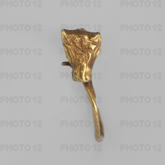 Earring decorated with a bull's head; bucranium ornament; pendant; goldsmithery; 3rd century BC; Greece; jewelry; height 1.5 cm, width 1.1 cm, depth 0.4 cm, weight 1 g; maker, Goluchów Greater Poland Voivodeship., A small metallic object with a worn, irregular surface in a gold color, showing a rounded top portion that tapers into a thin, curved stem; the background is a smooth light gray.
