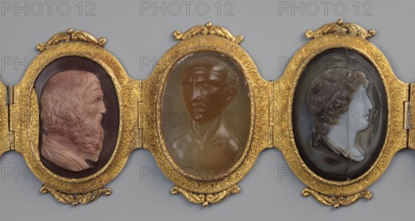 Bracelet with cameos, by Roniker, E. purchased; portraits, gems, goldsmithery; Roman period/19th century AD; origin, jewelry; height 4.2 cm, width 19.5 cm, The image shows a horizontal arrangement of three oval medallions set in an ornate gold frame with decorative flourishes; each medallion contains a raised profile bust. The left medallion features a bearded male profile in shades of warm pink and beige against a dark background, the central medallion shows a stern male bust in translucent brown tones, and the right medallion displays a clean-shaven classical profile in pale bluish-white and gray with darker hair. The surrounding frame is richly detailed and predominantly gold, and the background behind the framed medallions is a flat gray.
