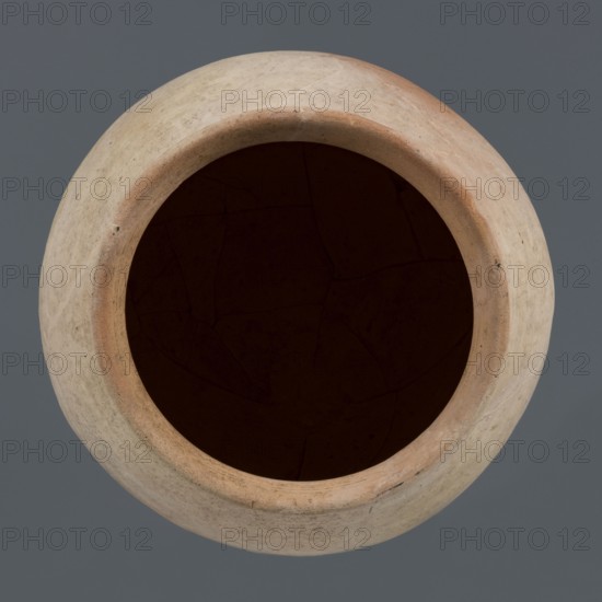 Spherical vessel, unknown northern Mesopotamian workshop; Early Jazira III period ca. 2600–ca. 2350 BC; clay; spherical vessel with an ovoid belly widening towards the top, small flat round bottom, short sloping shoulders merging into a low wide neck terminating in a rounded rim formed as a wide, thickened strip on the outside; Northern Mesopotamia Khabur basin, Tell Rad Shakra northeastern Mesopotamia, Syria; height 28 cm, width 28 cm., A top-down view of a round, open ceramic vessel with a wide mouth showing a dark interior; the outer surface of the vessel is pale beige with areas of light tan and subtle reddish-brown near the rim, small dark specks and faint surface texture are visible, and the background is a solid medium gray.