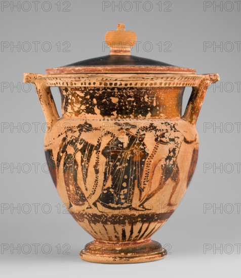 Column krater with lid, unknown Attic workshop. Black-figure krater with lid. Red clay, tinted with ochre. Black varnish with a muted lustre, fading to brown in places. The rim is decorated with a radial ornament and a schematic ivy sprig; the shoulders bear a series of vertical lines. The belly is decorated with figural scenes. Side A: Dionysus holding a cornucopia, accompanied by a satyr and a maenad. Side B: an archer flanked by two helmeted hoplites with round shields. Lid with a pomegranate-shaped handle, decorated with an ivy sprig on the rim. 520–510 BC, Attica. Vessel type: column krater. Weight 1.382 kg. Diameter 19.2 cm 22.5 cm with vices. Height 21.4 cm 22.6 cm with vices., An ancient-style ceramic vessel with a lid and two handles is shown, featuring a rounded body on a flared foot and a knobbed lid; the surface shows worn painted figures and patterns in dark brown to black against a warm terracotta background with areas of lighter beige where the paint has chipped, and the...