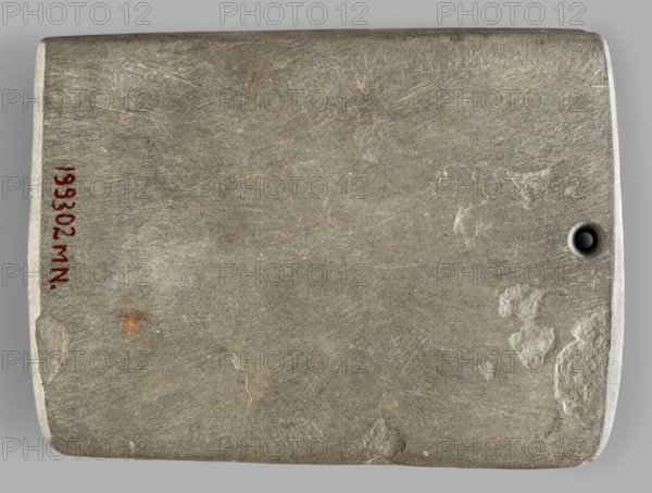 Rectangular paddle, flat with a hole at one of the shorter edges; possibly a whetstone. Ceremonial/toiletry geometric paddle, Predynastic Period Naqada III, 2nd half of the 4th millennium BC, Egypt. Height 8.2 cm, width 11.1 cm, weight 0.174 kg., inscription/author entries unspecified; provenance: Frombork Warmian-Masurian Voivodeship., A rectangular flat stone slab with rounded corners and a small circular hole near one short edge, showing a rough, scratched surface texture with patches of smoother wear and a few small areas of flaking; the visible colors are gray, light gray, brownish-gray, a few rusty brown spots, and a tiny hint of green.