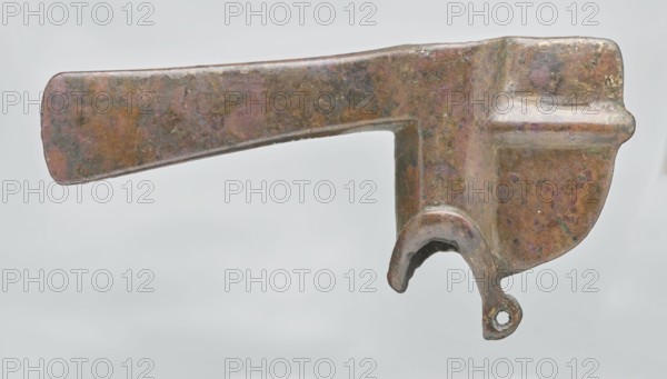 Battle axe, Eastern Gallic Scenography, 2nd half of 3rd millennium BC, Western Iran, weapon, weight 280 g, An object with a flattened, elongated arm and a thicker, rounded head is shown against a pale gray background; the metal surface displays mottled brown, green, and purple tones with areas of darker patina and some lighter highlights, and a curved hook-like projection extends downward from the thicker end with a small rounded loop at its tip.