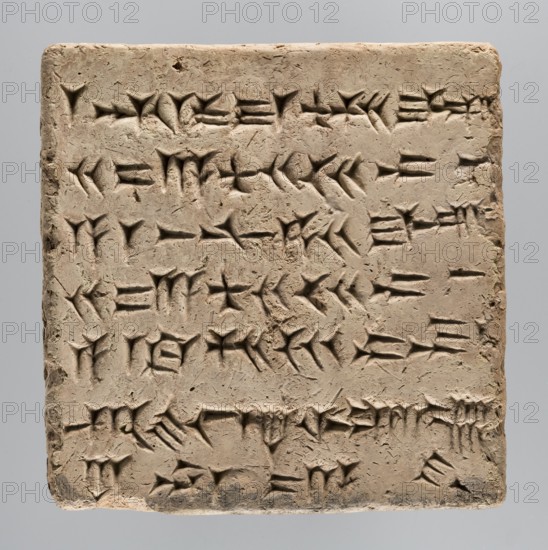 Brick with an inscription of King Shalmaneser III, Shalmaneser III 858–824 BC Shulmanu-ašared, king of the Neo-Assyrian Empire; Calah Iraq, the ziggurat at Kalhu commonly known as Nimrud; square brick with cuneiform inscription: upper surface inscribed over almost its entire surface with seven lines of carefully impressed cuneiform characters; sand-colored clay, one edge burnt to black; 858–824 BC; origin: Kalhu Nimrud; brick; weight 20.97 kg; width 35 cm; length 35 cm; thickness 12 cm., A rectangular clay tablet with a rough, textured surface in shades of beige and light brown fills the image; the tablet shows a few shallow, angular impressions forming repeated wedge-like grooves and triangular indentations across its face, with slightly darker shadows inside those indentations; the tablet edges are worn and irregular, with some small chips and a slightly darker brown discoloration along the bottom edge; the background is a smooth, neutral gray that contrasts with the tablet's earthy ...