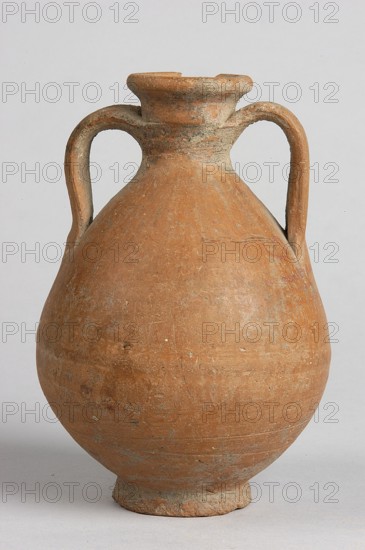 Pelike, decoration painted on the firnis: between the handles on both sides a wavy linear tendril with volute-like curled side shoots; above it a wavy line twist?. At the height of the base of the handles, two horizontal parallel lines. 332–30 BC Hellenistic period. Unknown place of origin. Vessel; height 12.5 cm, width 9.8 cm., An earthenware vessel with a rounded body and a narrow neck flaring to a short rim, showing a textured surface with some rough patches and chips, and two symmetrical looped handles extending from the neck to the shoulder; the object is predominantly terracotta orange with areas of lighter beige and grayish weathering, set against a pale neutral background.