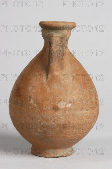 Pelike; decoration painted on the firnis: between the handles on both sides, a wavy linear tendril with volute-like curled side shoots. Above it, a wavy line twist?. At the height of the base of the handles, two horizontal parallel lines. 332–30 BC; Hellenistic period., Vessel; height 12.5 cm, width 9.8 cm., A rounded, bulbous clay vessel with a narrow neck and a short flared rim, featuring a single vertical handle running from the rim to the shoulder; the surface is textured and worn with patches of roughness and small pits, showing shades of terracotta, brown, and muted grayish areas, set against a plain light gray background.