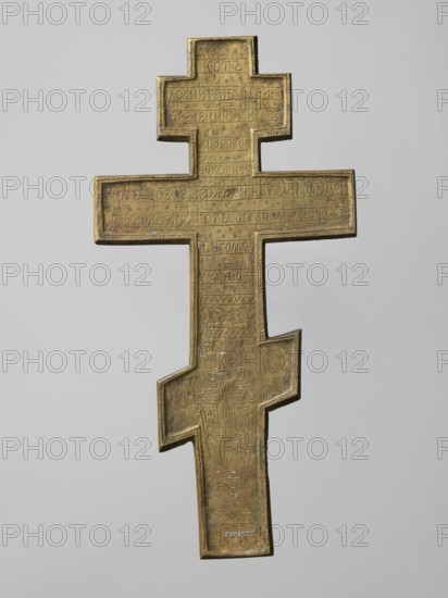 Cross: Crucifixion of Christ, Old Believer Popovtsy workshop; crosses; Lord of Hosts iconography; Jesus Christ Bible; God the Father iconography; the moon iconography; Crucifixion iconography; the sun iconography; Adam Bible; Golgotha iconography; skull iconography; instruments of the Passion of the Lord iconography; Jerusalem Israel/Palestine; the Holy Spirit iconography; ornaments; inscriptions; halo iconography. On the eight-pointed cross is an image of the Crucifixion. Below the cross on which Christ is suspended is a grotto with Adam's skull and the tree of Seth; at the level of the footstool is a view of Jerusalem; on either side of Christ on a long beam are the sun and the moon. In the upper part, a bust-like image of the Lord of Hosts is depicted, below which is the dove of the Holy Spirit. The relief is deep and the style is rather schematic, somewhat archaizing especially visible in the facial features. The reverse is engraved with the words of a prayer to the Holy Cross and ...