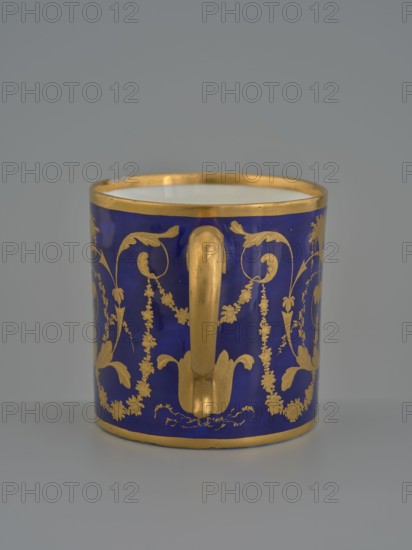 Cup, Manufacture nationale de porcelaine de Sèvres 1756–, manufacturer, 1803–1804, Sèvres; porcelain vessel, height 7.5 cm., A cylindrical cup with a deep blue exterior decorated with ornate gold floral and vine patterns, a gold handle attached at the front, and gold trim along the rim and base; the interior appears white, and the background is a soft grey.