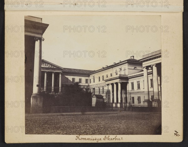 Kommissya Skarbu Palace of the Government Commission of Revenue and Treasury of the Kingdom of Poland at Bankowy Square according to the design of architect Antonio Corazzi, photograph by Karol Beyer 1818–1877, 1861–1863. Subject: palace of the Government Commission of Revenue and Treasury, Bankowy Square, Rymarska Warsaw. Photography; photographic print: height 7.6 cm, width 8.7 cm; mount: height 11.3 cm, width 8.8 cm., A sepia-toned photograph of a classical building with tall columns and an ornate pediment, framed by a few large columns in the foreground and a metal fence running across the scene; the building shows a long facade with several windows and architectural details, and there is a paved cobblestone surface in front; the visible colors are brown, beige, cream, black, and dark gray.