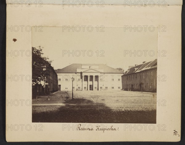 Warsaw. Resursa Kupiecka Former Mniszech Palace at Senatorska Street, Beyer, Karol 1818–1877 photographer/creator, Mniszech Palace Warsaw, Warsaw Masovian Voivodeship, cobblestones, street lamps, Senatorska Warsaw; street, 1861–1863, photography, nature photography, photographic print: height 6.2 cm, width 8 cm, backing: height 11.3 cm, width 8.8 cm, A sepia-toned photograph framed by a cream-colored border shows a wide cobblestone square leading to a neoclassical building with a triangular pediment and columns at its entrance, flanked by lower buildings on both sides; a tall streetlamp stands near the center foreground, trees and darker facades appear on the left, and lighter-colored buildings with pitched roofs line the right, with tones of brown, beige, cream, black, and muted gray throughout.