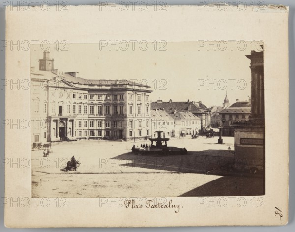 Theatre Square View of the Town Hall and Blanka Palace from Wierzbowa Street towards Castle Square, Karol Beyer 1818–1877, 1861–1863. Photograph photographic print, height 6.2 cm, width 9.3 cm; backing: height 11.3 cm, width 8.8 cm. Depicts Town Hall Warsaw; 1818–1944, Blanka Palace, Grand Theatre building, Jablonowski Palace, fountains, streetlamps, fire brigade, Senatorska Street, Wierzbowa Street, Castle Square; nature photography; Warsaw Masovian Voivodeship., A sepia-toned photograph shows a large open square bordered by a grand multi-story classical building on the left with many windows and decorative façades in light beige and pale brown tones; a group of smaller pitched-roof buildings in muted beige and gray tones lines the middle distance; a darker stone fountain with a few silhouetted figures sits near the center casting a shadow across the square; a tall columned structure in dark brown appears at the right edge; the ground is a mix of light sandy beige and darker shadowed ...