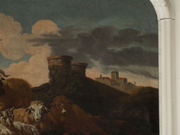 Shepherd Scene with a View of the Castle, Roos, Philipp Peter 1657–1706 painter. Multicolored composition with dominant shades of brown against a blue sky with white clouds and a distinct pink glow. In the foreground, the central group consists of two goats, a male and a female, lying down, with a male goat standing behind them. On the left, a slope, a dog, and a shepherd sitting in half-profile, wearing a brown sheepskin coat, blue trousers, a white shirt, and stockings. On the right, in the background on a hill, two cylindrical buildings with castle buildings behind them. 18th century, Italy; overdoor; height 92.0 cm, width 115.0 cm., A painted scene showing a group of animals in the foreground including several sheep with white and brown wool and a brown cow, positioned before a dark, rocky hill topped by two round stone towers. Behind the hill there is a cluster of small buildings with red roofs and pale walls and a taller square tower among them. The sky above contains large pale ...