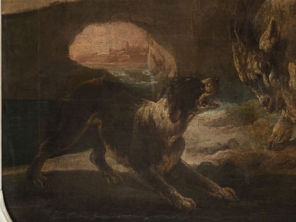 A dog scene with a dog barking at a goat, Roos, Philipp Peter 1657–1706 painter. The general tone of light browns and shades of pink with cumulus clouds, the glow of the last plane beyond the arcade of the bridge with ruined buildings surrounds the view of urban buildings by the river. In the foreground, a dog barking at a goat that is attacking it; on the right side, a sheep lying near a tree trunk. 18th century, Italy; overdoor. Height 90.0 cm, width 115.0 cm., A dark-toned painting shows a dog in a defensive or alert posture facing another animal partially visible at the right edge. The dog has a mix of brown, black, and cream fur with lighter highlights on its chest and legs, and its mouth is open showing teeth. The animal on the right displays coarse fur in shades of brown and gray and appears larger and more textured. The background includes a cave-like opening with muted pink and peach tones visible through it, surrounded by deep browns and dark greens, and a ground area rendere...
