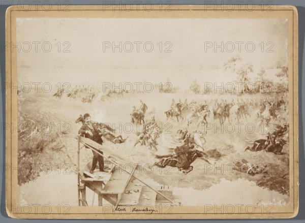 Painting the Raclawice Panorama: one of the painters Zygmunt Rozwadowski? standing on scaffolding by a canvas depicting a fight between Polish and Russian cavalry. Photograph of artists' studios showing painters, scaffolding, painting accessories; depiction relates to the Raclawice Panorama. Reproduction of painting by Wojciech Kossak and Jan Styka; photographers Hamel and Feigl. Print glued to cardboard backing; photographic print 11.8 × 17.1 cm, pad 13.5 × 18.5 cm; dated 1893/1894; photography from nature; style: painting panoramas, portraits., A sepia-toned scene shows a man standing on a wooden platform or scaffold above a body of water, wearing a dark suit and hat, holding onto the railing with one hand and resting the other on his hip; below and beyond him a dynamic group of mounted riders charge across open ground with several horses and riders falling or rearing, and a few figures lying on the ground; the background contains a few trees and open fields, and the overall colors v...