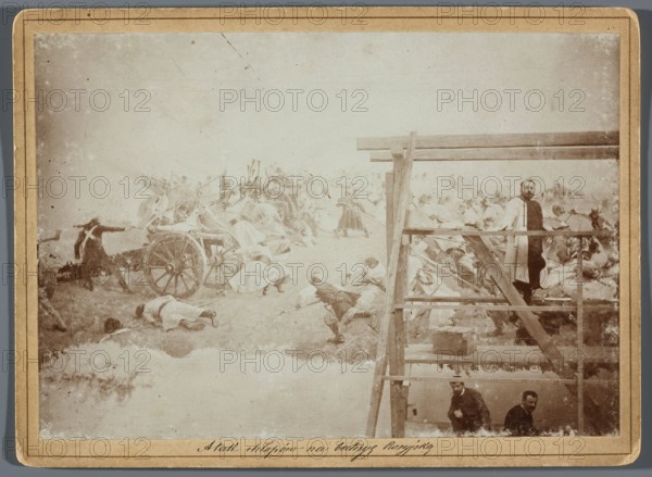 Painting the Raclawice Panorama: Jan Styka standing on scaffolding by a section of the canvas depicting the capture of a battery of Russian cannons by the leading group of the first column of scythe-bearers, Hamel and Feigl; photographic print glued to cardboard; ca. 1893–1894; photographer, reproduction of Wojciech Kossak and Jan Styka; subjects include panorama painting, artists' studio, scaffolding; dimensions of photographic print 11.9 × 17.1 cm, cardboard 13.5 × 18.5 cm., The image shows a pale, sepia-toned scene with a large painted or staged battle on the left and a wooden scaffold structure on the right; the battle area contains a group of figures in light-colored clothing near a wheeled cart, with some figures lying on the ground and others in dynamic poses, and darker-clothed figures appearing among them; the scaffold has a few men standing or crouching on its platforms, one man in a light coat standing near the upper railing, and two men lower down; visible colors include be...