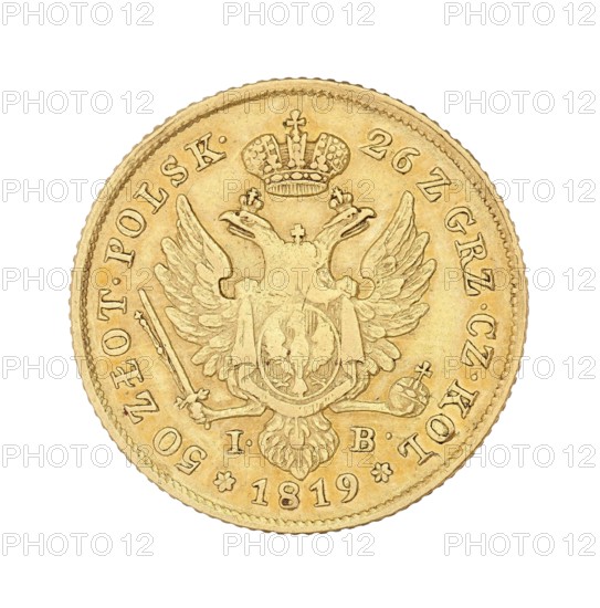 Polish double zloty 50 zloty, 1816. Designer/co-creator: Jakub Benik 1772–1827, Intendant of the Mint; author: Alexander I Romanov Emperor of Russia; King of Poland; 1777–1825. Mint: Warsaw. Coin., A round metallic object with a golden color fills most of the image against a white background, showing a raised decorative rim and detailed embossed imagery including a double-headed bird with outstretched wings, a crown above the bird, a shield over its chest, and ornamental elements like a scepter and orb near the lower sides; the surface shows variations in the gold tone with slightly darker and lighter areas accentuating the engraved details.