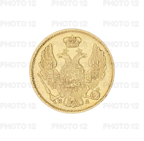 3 rubles = 20 zlotys; Nicholas I Pavlovich Tsar of Russia; 1825–1855 author; St. Petersburg; coin, A round metallic coin with a raised double-headed eagle design and a crown above it, showing detailed feathers and ornamental shields on the wings; the coin surface appears textured and worn in places, with a beaded rim around the edge. The visible colors are gold and shades of yellow, with slight darker brownish-yellow areas where the relief and wear create shadows.