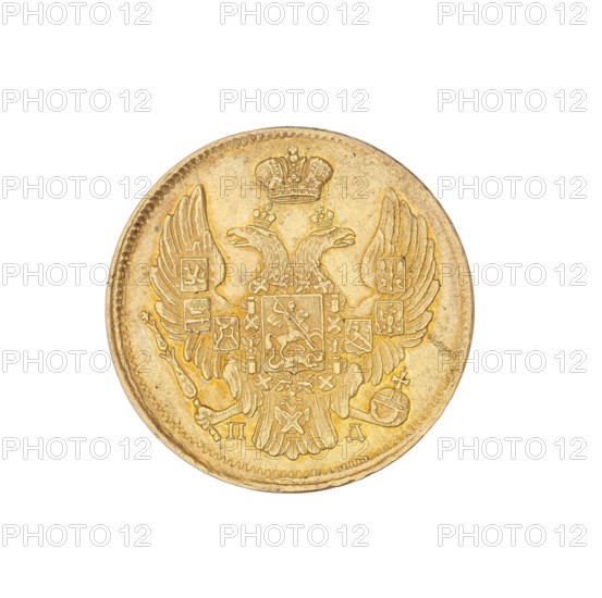 3 rubles = 20 zlotys; Nicholas I Pavlovich Tsar of Russia; 1825–1855 — ruler creator/authority; St. Petersburg — mint; coin., A round coin with a central raised double-headed eagle motif wearing a crown, detailed wings extending toward the edges, and an ornate shield-like emblem at the center; the surface shows worn textures and fine engraved patterns with a beaded rim. The visible colors are gold and pale yellow with subtle darker golden-brown shading in recessed areas.