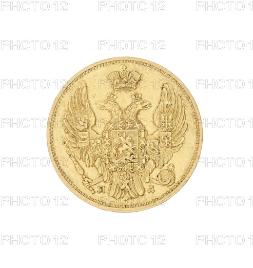 3 rubles = 20 zlotys; Nicholas I Pavlovich Tsar of Russia; 1825–1855 author; St. Petersburg; coin, A round gold-colored coin with an embossed double-headed eagle at its center, each head wearing a small crown and a larger crown depicted above them, a detailed shield with ornate patterns sits on the eagle's chest, the eagle's wings are spread and show feather detailing with additional small shields on the wings, the eagle holds a scepter and an orb in its talons, the coin edge has a raised rim with a beaded border, the metal surface shows slight wear and variations in golden tones.