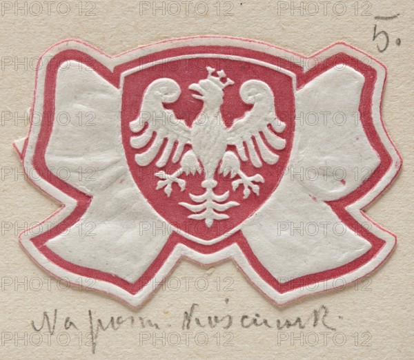 Lowicz. World War I period prints, charity, Poland, wars, Lowicz Lódz Voivodeship, World War I 1914–1918, stamps, 20th century, stamps, A die-cut paper emblem shaped like a bow with a central shield shows an embossed bird with spread wings and a small crown, all in white, set against a red background inside the shield; the bow portion is primarily white with a red outline, and the background behind the emblem is a beige textured paper.