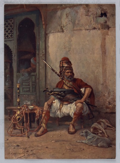 Reproduction of a painting: Stanislaw Chlebowski 1835–1884, Albanian, 1877; reproduction of a work of art, album illustration, illustration; subject/themes: oriental scene, oriental costumes, water pipes, dogs; medium: painting reproduction; dimensions: height 23.3 cm, width 16.3 cm; date: 1908., A seated man wearing a layered headwrap and a red cloak over white draped clothing occupies the center, holding a long firearm and a curved blade at his waist, with patterned red and gold leg wraps and brown shoes. To his left is a low table with a tall ornate metal hookah or pipe with hoses draped around it, a small cup, and a glass. Behind him is a carved doorway or window with dark interior shadows and a muted green frame. The background shows a weathered wall in tones of beige, tan, and gray with patches of darker discoloration. On the ground in front lie a few coils of rope or hose in reddish-brown and gold, and two dogs resting—one pale gray and one with brown and tan fur. The overall pa...