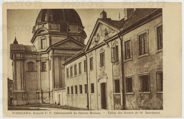 Warsaw. Church of the Blessed Sacrament Nuns in the Old Town. - Eglise des Soeurs de St. Sacrement, Bulhak, Jan 1876-1950 photographer, Church of the Blessed Sacrament Nuns Warsaw; New Town Market Square, Warsaw Masovian Voivodeship, ca. 1930, postcard, height 9 cm, width 13.8 cm, A sepia-toned photograph of an architectural street view showing a large domed building adjacent to a row of connected buildings with decorative facades and multiple windows. The dome and its supporting structure appear on the left, with classical architectural details and pilasters, while the row of lower buildings stretches to the right featuring a central entrance topped by sculpted ornamentation and a triangular pediment. Several windows are visible along the façades, some with open shutters, and the exterior surfaces show texture and weathering. The street in front is mostly empty, and the overall color palette includes shades of brown, tan, beige, and cream.