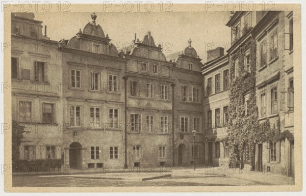 Warsaw. Kanonja Street, St. Wojciech's Printing House and Bookstore; co-creator Bulhak, Jan 1876–1950, author/photographer; publisher: Polish Society of Railway Bookstores Ruch, Sp. Akc.; place of creation: Warsaw, Kanonia street, ca. 1930; postcard; 9 × 14 cm., The image shows a row of multi-story buildings viewed from a courtyard, rendered in muted sepia tones of brown, tan, and beige; the central building features ornate rooflines with decorative domes, and several rectangular windows across the facades; to the right, a building facade is partially covered by climbing vegetation with textured leaves in darker brown, and a narrow street lamp stands near the buildings; the ground area in front appears paved and flat, and the overall scene includes architectural details like window frames, doorways, cornices, and subtle shadows across the walls.