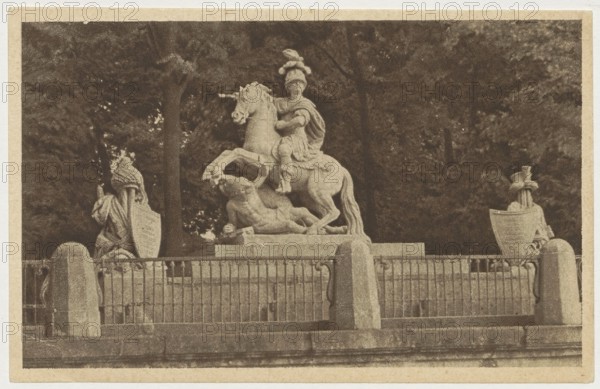 Warsaw. Monument to King Jan Sobieski, photograph by Jan Bulhak 1876–1950; co-creator: St. Adalbert's Printing House and Bookstore Poznan; publisher: Polish Society of Railway Bookstores Ruch; subject: monument to Jan III Sobieski Warsaw; place of creation: Warsaw, Masovian Voivodeship; date: ca. 1930; medium: postcard; dimensions: 9 × 14 cm., A stone equestrian statue of a helmeted rider on a rearing horse stands on a raised stone base, with the horse’s hooves and a reclining human figure beneath; the sculpture is framed by a metal railing with stone posts and flanked by two draped statues or sculptural forms on either side, all set against a backdrop of dense trees. The visible colors are sepia tones, brown, beige, and off-white.