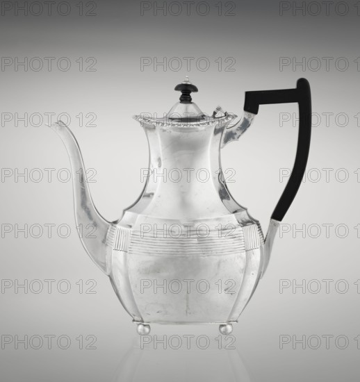 Coffee pot by Harris, CS & Sons London, goldsmiths' firm, fl. 1817–1933 and Harris, Charles Stuart maker, fl. 1852–1897. Scrap-purchased. Pear-shaped, ribbed coffee vessel with godron ornaments; supported on four ball-shaped profiled legs; belly decorated with a band of narrow half-cylinders and grooves. High side spout-like handle and a contemporary wooden axial handle set in silver sockets. Upper edge edged with a godron band; hinged lid domed in the center, topped with a bowling-pin finial. Dated 1895/1896, London, England. Height 21.2 cm; width 18.5 cm; depth 10 cm; weight 640 g., A reflective metal teapot with a curving spout and a high-arched handle is shown against a light gray gradient background; the teapot has a polished silver surface with subtle scratches and scuffs, a domed lid topped with a small dark knob, decorative fluting around the midsection, rounded body panels, and small round feet, and the handle appears dark black while the overall scene includes shades of silve...