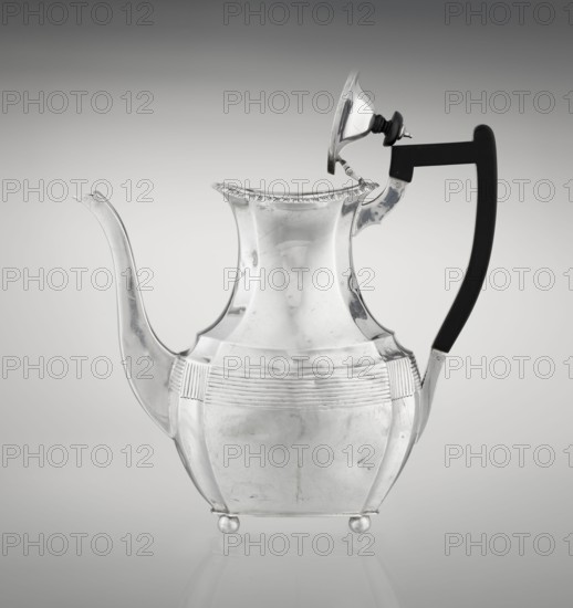 Coffee pot by Harris, CS & Sons London; goldsmiths' firm, fl. 1817–1933 and Charles Stuart Harris maker, fl. 1852–1897. Purchased; scrap - purchased. Pear-shaped, ribbed coffee vessel with godron ornaments; supported on four profiled, ball-shaped legs. Belly decorated with a band formed by narrow half-cylinders and grooves. High spout-shaped side handle; wooden handle contemporary addition set on the axis in silver sockets. Upper edge edged with godron band; hinged lid domed in the center, topped with a bowling-pin finial. Dated 1895/1896. Great Britain, London. Vessel. Height 21.2 cm; width 18.5 cm; depth 10 cm; weight 640 g., A reflective metal pitcher with a curving spout and a high, flared neck sits against a smooth gradient background; the body is rounded with ribbed horizontal decoration around the midsection and rests on small round feet, while a hinged lid is propped open and a dark, curved handle attaches to the side. The visible colors are metallic silver on the pitcher, blac...