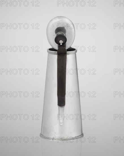 Coffee pot, maker: Barnard, Edward & Sons Ltd London; goldsmith's firm; fl. ca. 1680–, maker: Clark, Alfred Ltd London; goldsmith's firm and sellers; fl. 1898–1934; conical coffee pot with hinged lid, slightly arched and flattened at the top, topped with a wooden handle made; spout short, with two sleeves on the axis for attaching a wooden handle added contemporarily; on the mantle engraved monogram tied HH under a ducal mitre, dated 1890/1891; material: silver with wooden handle; function: coffee ware; place: London, England, Great Britain; vessel dimensions: height 17.3 cm, width 11 cm, depth 8.4 cm; weight 627 g., A tall metallic pitcher with a conical shape stands against a light gray background; it has a reflective silver surface showing subtle scuffs and spots, a dark brown vertical handle attached near the top and extending down toward the spout, a rounded lid with a knob that is open and tilted back, and a short tapered spout near the base.