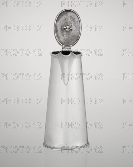 Conical coffee pot with hinged lid, slightly arched and flattened at the top, topped with a wooden handle; short spout on the axis with two sleeves for attaching a wooden handle added contemporarily. Mantle engraved with tied monogram HH beneath a ducal mitre; stamped/marked Barnard, Edward & Sons Ltd London; goldsmiths, fl. ca. 1680–, and Clark, Alfred Ltd London; goldsmiths and sellers, fl. 1898–1934. Materials: silver with wooden handle. Date: 1890/1891. Place: London, England, Great Britain. Function: coffee ware. Dimensions: height 17.3 cm, width 11 cm, depth 8.4 cm; weight 627 g., A tall metallic pitcher with a smooth, slightly tapered body and a reflective silver surface stands upright against a plain light gray background, its hinged oval lid open to reveal a darker, textured inner surface and a small round fastening, the top rim showing a scalloped triple-spout opening with darker interior shadows and subtle wear marks, and the base edged with concentric ridges and faint scuff...