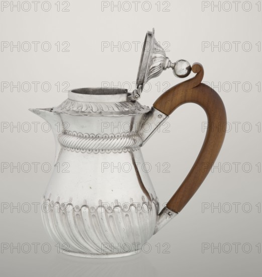 Coffee pot by John Septimus Beresford London goldsmith's firm; active 1880–89. Pear-shaped jug, spirally chased in the lower part, smooth above, decorated with a half-cylinder under the upper flared rim; short beak-shaped spout; wooden handle not original mounted in sleeves; hinged domed lid, spirally knotted, topped with a ball. 1888–1889. Great Britain, England, London. Vessel. Height 13 cm; width 12 cm; depth 6.8 cm; weight 179 g., A single metal pitcher with an open hinged lid and a curved wooden handle is shown against a plain light background; the pitcher has an ornate embossed design with a band of rope-like decoration and scalloped borders, a fluted lower body, a short spout, and a rounded base, and the handle is smooth and polished wood in a warm brown tone while the metal surface is reflective silver with some darker tarnished spots.