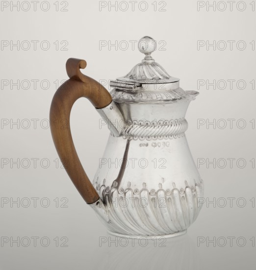 Coffee pot by John Septimus Beresford London; goldsmith; active 1880–1889. Pear-shaped jug, spirally clacked in the lower part, smooth above, decorated with a half-cylinder under the upper flared rim; short spout; wooden handle not original mounted in sleeves; hinged domed lid, spirally knotted, topped with a ball. 1888–1889, London, England, Great Britain. Vessel. Height 13 cm; width 12 cm; depth 6.8 cm; weight 179 g., A reflective metal pitcher with ornate ridged and scalloped detailing and a hinged domed lid topped by a round finial sits against a plain light background, featuring a curved wooden handle in warm brown with a curled top attached to the body by metal fittings; the pitcher shows polished silver tones along with subtle darker reflections and the brown of the handle.