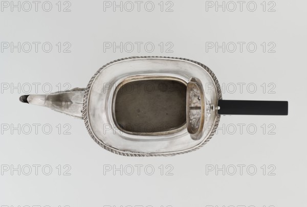 Teapot by Henry Moreton fl. 1899–1930s, factory owner and goldsmith; neo-Rococo style, silver, 1909–1910. Egg-shaped teapot on an oval plinth with a side spout, sleeves for attaching a wooden handle mounted on the axis, hinged centrally arched lid topped with a handle. Upper edge bordered with a band of godrons and a wide collar; decorated overall with neo-Rococo relief motifs and acanthus leaves, with an oval blind reserve on the belly framed by an acanthus rim. Function: tea vessel. Dimensions: height 13.5 cm, width 26 cm, depth 12 cm; weight 555 g. Place of origin: Chester, England., A metallic teapot is shown from above with a rounded rectangular body and an open lid revealing a hollow interior; the teapot has a decorative twisted rim and an elongated spout extending to one side, with a straight dark handle on the opposite side. The visible colors are silver tones on the metal, a dark gray interior, and black on the handle, all set against a pale neutral background.