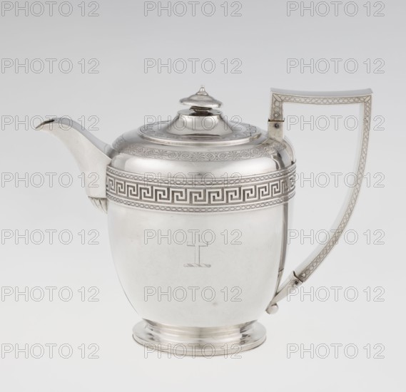 Teapot by John Emes fl. 1796–1808, goldsmith. Ovoid Georgian/George III teapot on a circular base with lid, c. 1806–1807, London, England. Decorated on the upper part of the belly with a wide band of meander ornament and braid. Ribbon-shaped, broken handle decorated with braid; high-set spout decorated at the base with a stylised palmette; lid finished with a knob-shaped finial. Engraved coat of arms on one side of the belly and a cross on the other. Materials: silver vessel. Dimensions: height 17.9 cm, width 23.7 cm; weight 815 g. Style: Empire/Georgian., A polished metal teapot with a reflective silver surface, featuring a curved spout on one side and a tall angular handle on the other, a domed lid with a small finial on top, a decorative band with a geometric pattern around the upper body, an engraved simple cross motif on the front, a rounded base, and a plain light gray to white background; visible colors include silver, gray, and white.